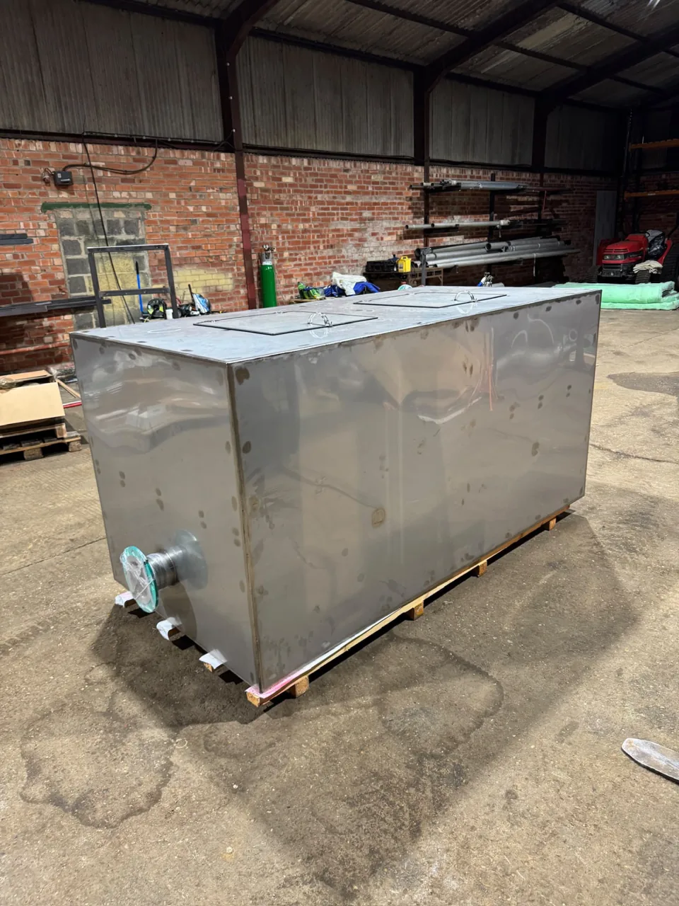 Stainless fabricated tank with projecting flanges inside the workshop